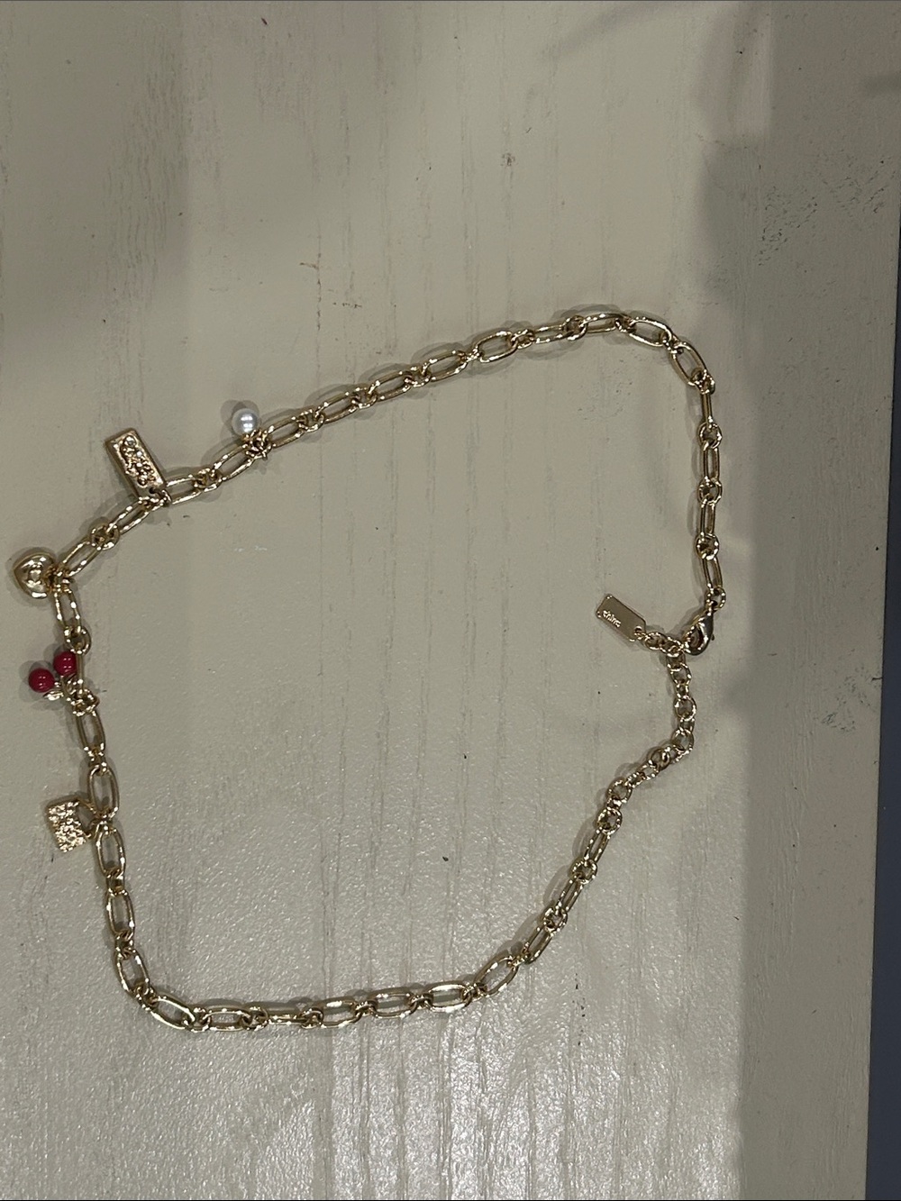 Coach Gold-Tone Charm Necklace with Red Bead and Pearl Accent